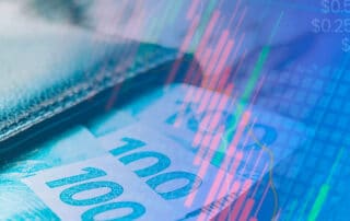 Imagem de capa da matéria Como um advogado iniciante pode ganhar dinheiro mostrando notas de 100 reais saindo de uma carteira e números representando a cotação da bolsa