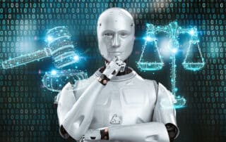 Como capa da matéria “Uso da Inteligência Artificial no Direito”, vemos um Robô com mão no queixo, ao seu lado um holograma da balança da justiça em azul e do outro lado, um holograma de um martelo de juiz.